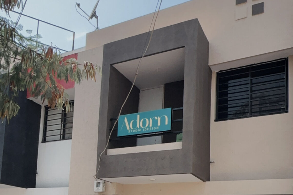 The Adorn Studio & Design building on Nana Mava Main Road, with the teal Adorn sign on the first floor